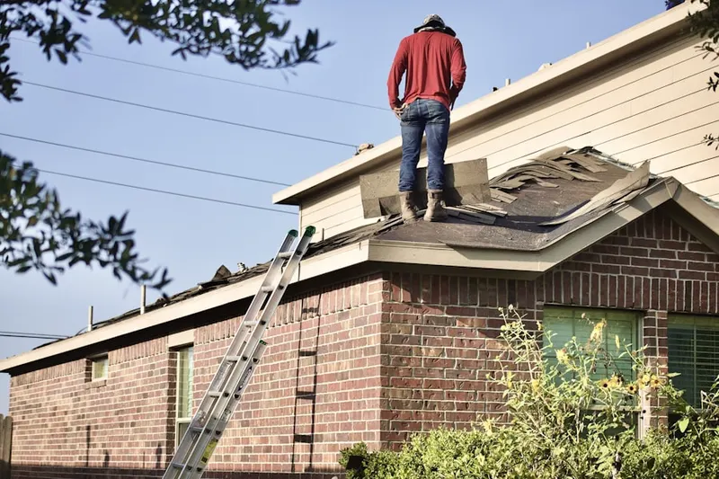 Professional roofer working on a residential roof in Northwest Santa Ana